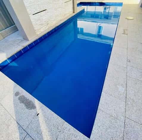 Clear aqua blue swimming pool which is being heated.