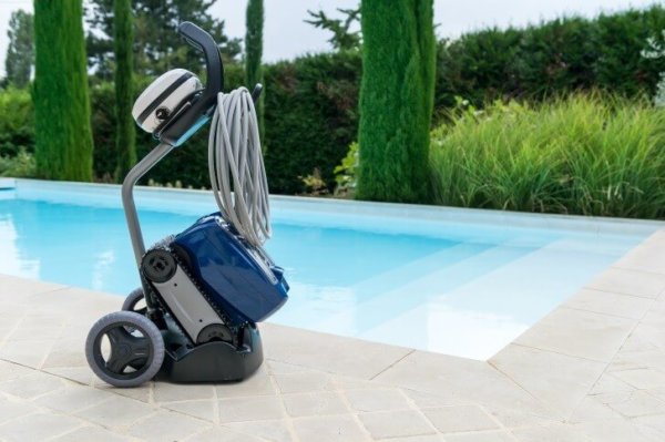 Zodiac TX35 Tornax robotic pool cleaner next to a swimming pool.