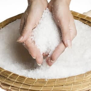 Mineral salt for swimming pool in a basket against a white background.